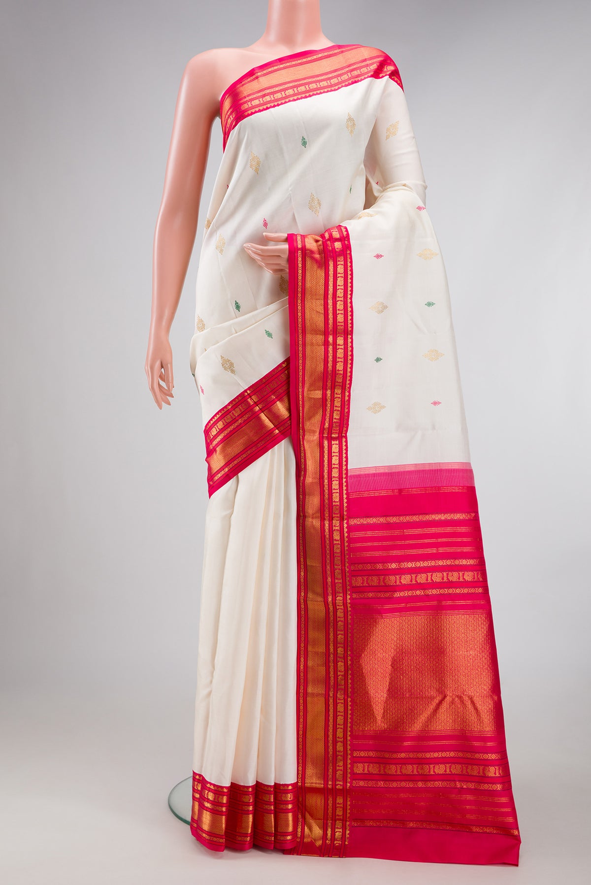 White Kanjivaram Silk Saree with Zari And Thread Butta on the body and Zari Border.  displayed on a mannequin