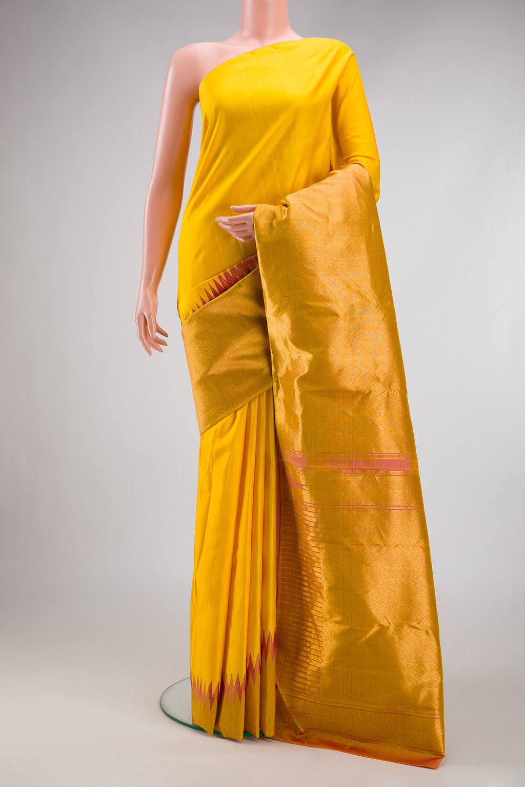 Yellow Kanjivaram Silk Saree with Plain Body and Rising Temple Border.  displayed on a mannequin