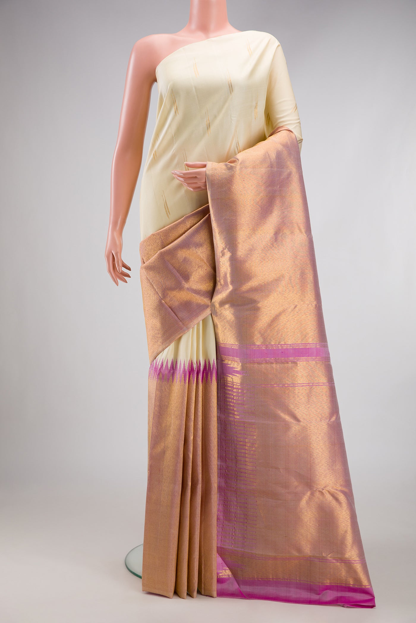 Off White Kanjivaram Silk Saree with Zari Butta on the body and Rising Temple Border.  displayed on a mannequin