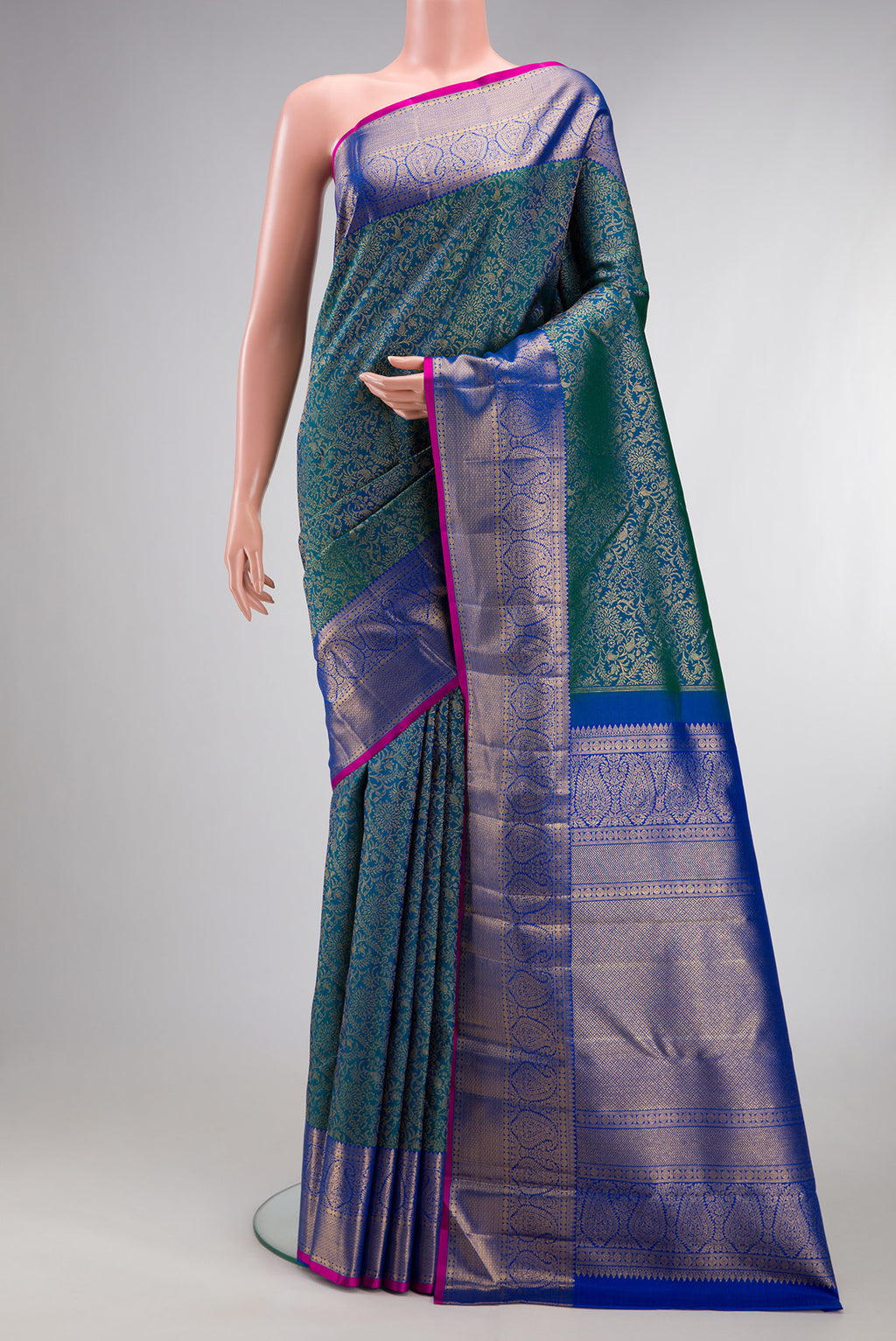 Pure Silk Peacock Blue Kanchipuram Saree with Zari Brocade on the body and Zari Border.  displayed on a mannequin