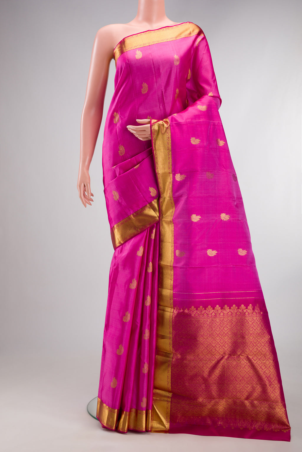 Pure Silk Rose pink Kanchipuram Saree with Zari Butta on the body and Zari Border.  displayed on a mannequin