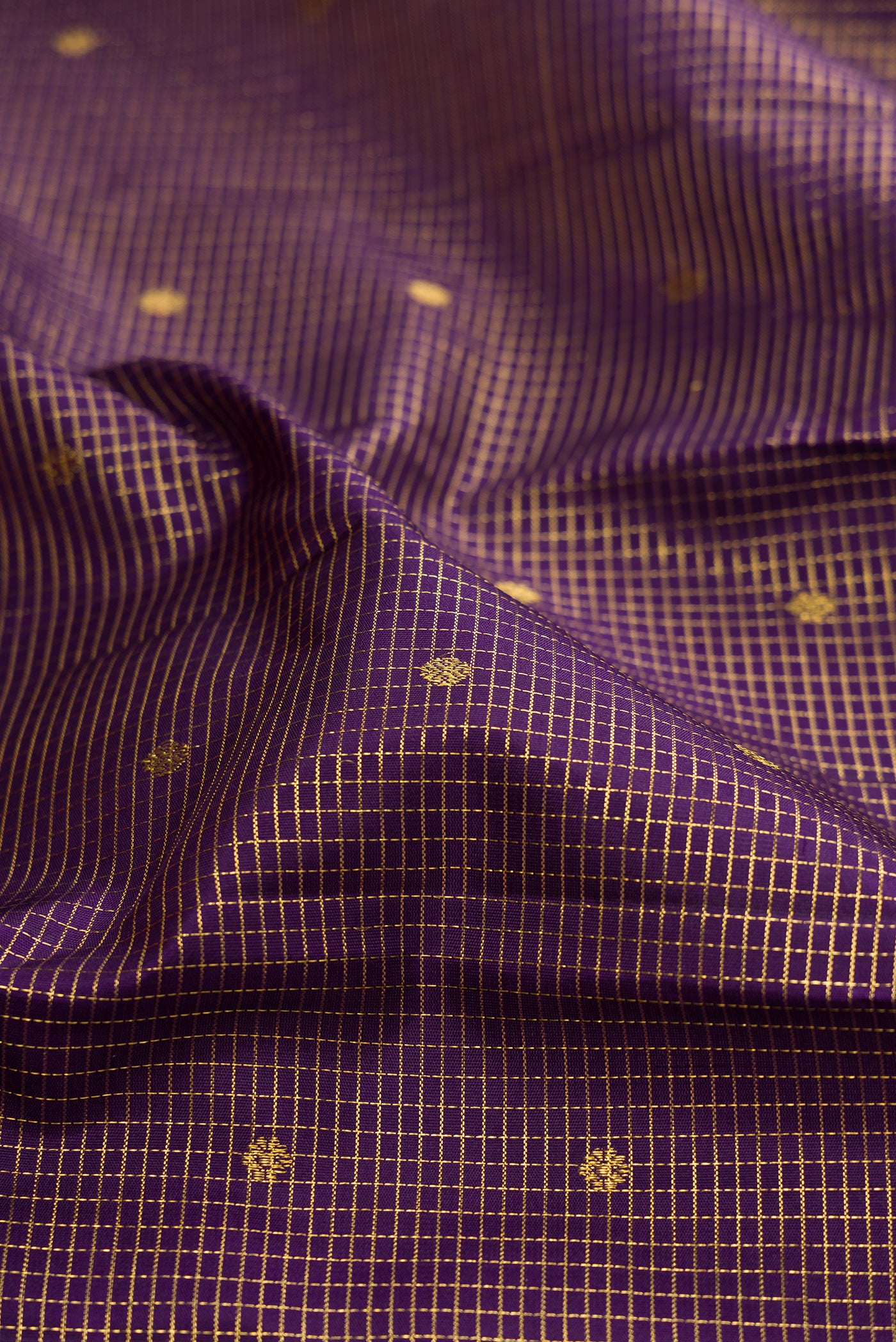 Close up of Purple Kanjivaram Silk Saree with Checked design on the body and Zari Border.  displaying folds
