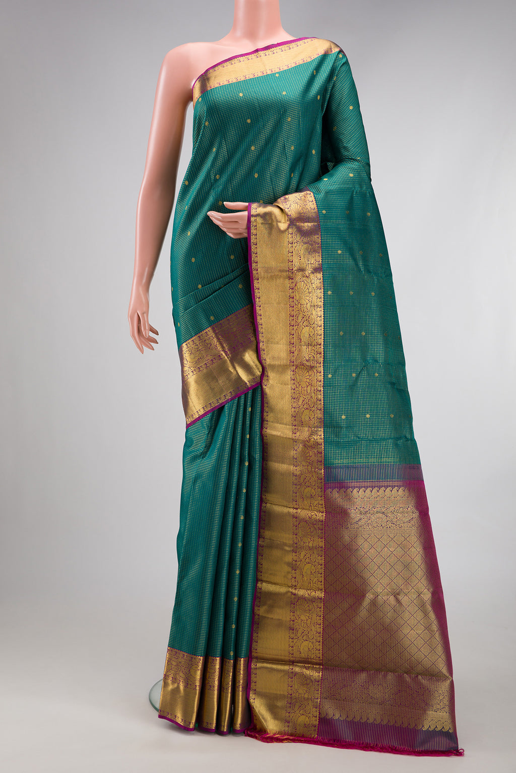 Green Kanjivaram Silk Saree with Checked design on the body and Zari Border.  displayed on a mannequin