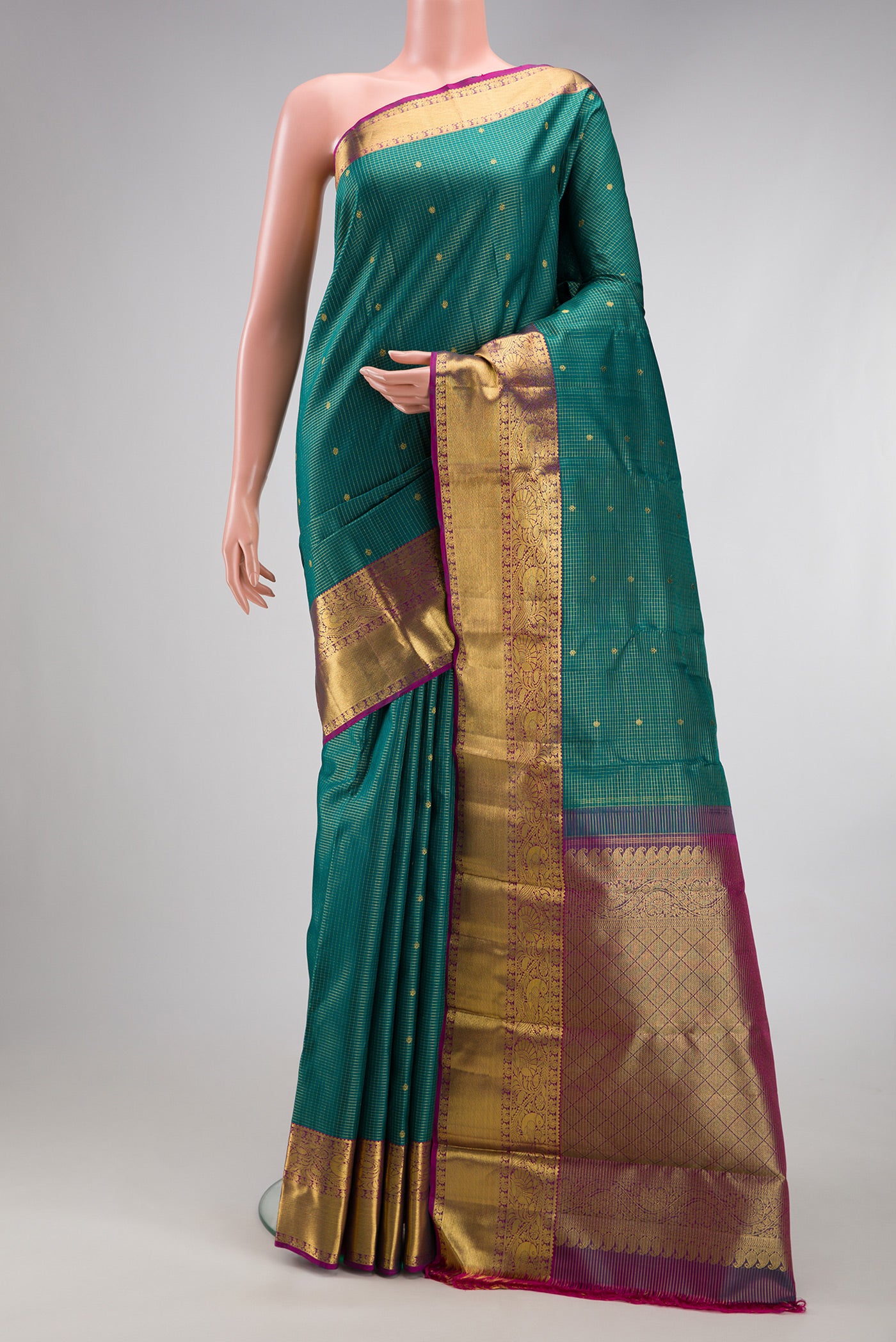 Green Kanjivaram Silk Saree with Checked design on the body and Zari Border.  displayed on a mannequin