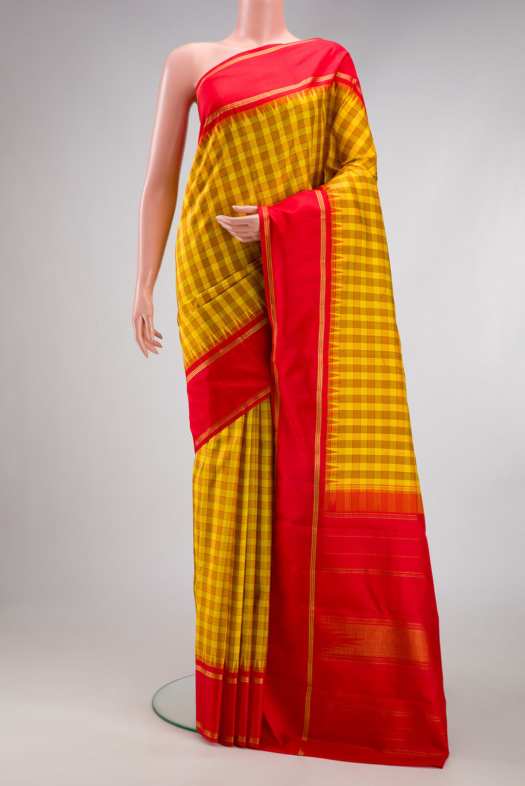 Yellow Kanjivaram Silk Saree with Checked design on the body and Zari Border.  displayed on a mannequin