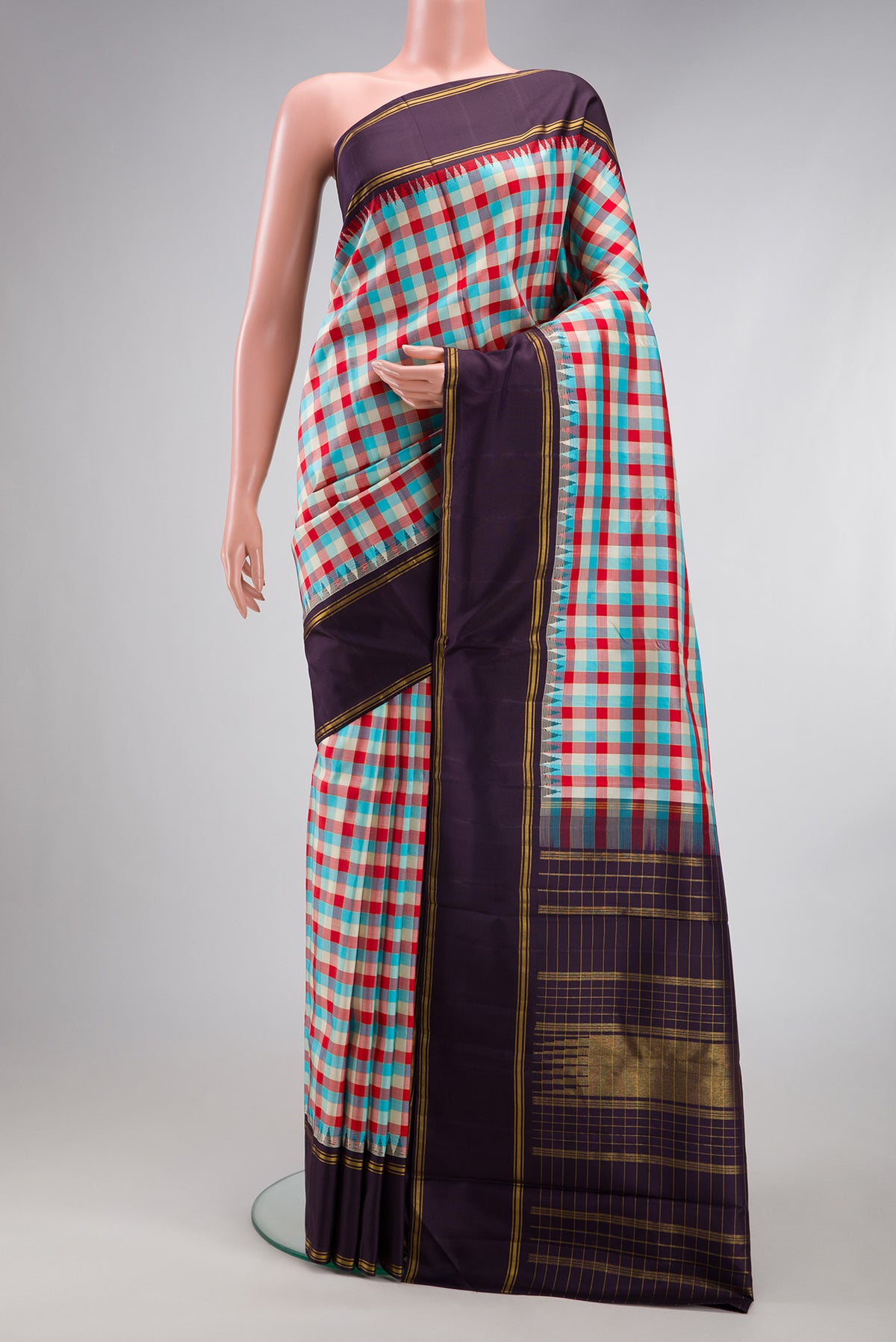 Multi Color Kanjivaram Silk Saree with Checked design on the body and Fancy Border.  displayed on a mannequin