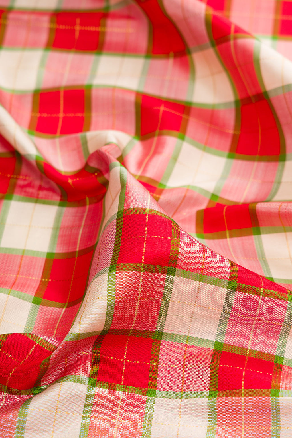 Close up of Multi Color Kanjivaram Silk Saree with Checked design on the body and Plain Border.  displaying folds