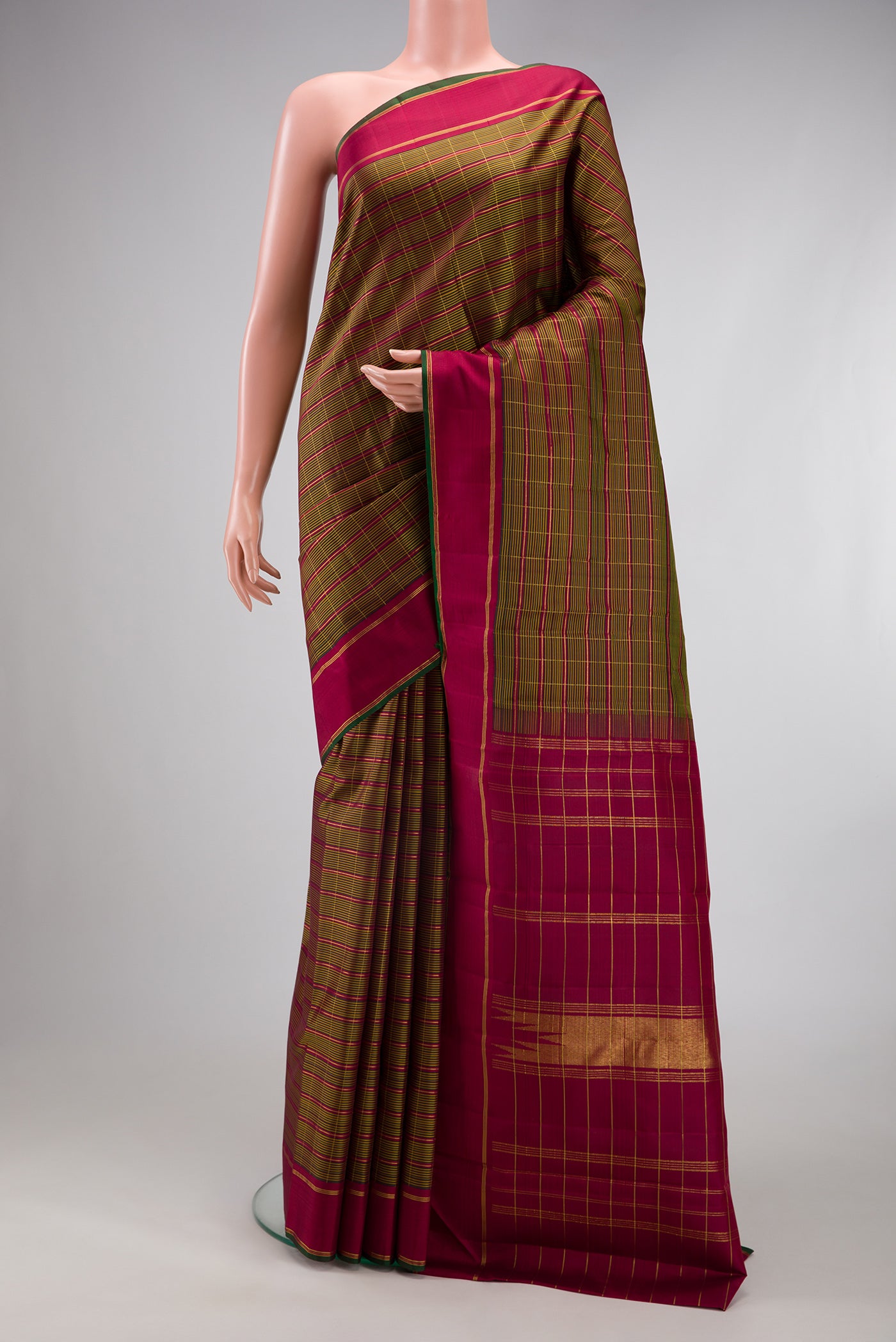 Mehandi Green Kanchipuram Silk Saree with Checked design on the body and Zari Border.  displayed on a mannequin