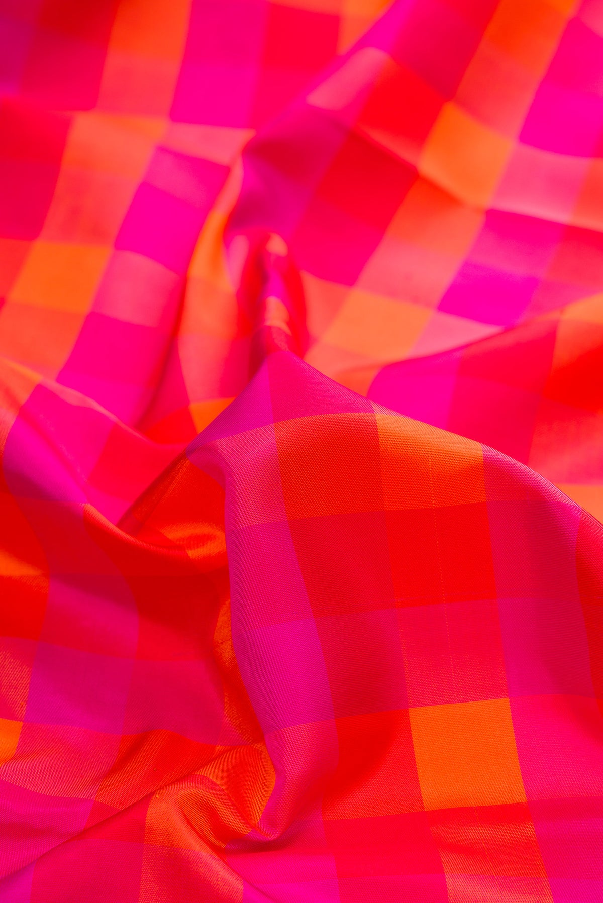 Close up of Pure Silk Multi Color Kanchipuram Saree with Checked design on the body and Without Border.  displaying folds