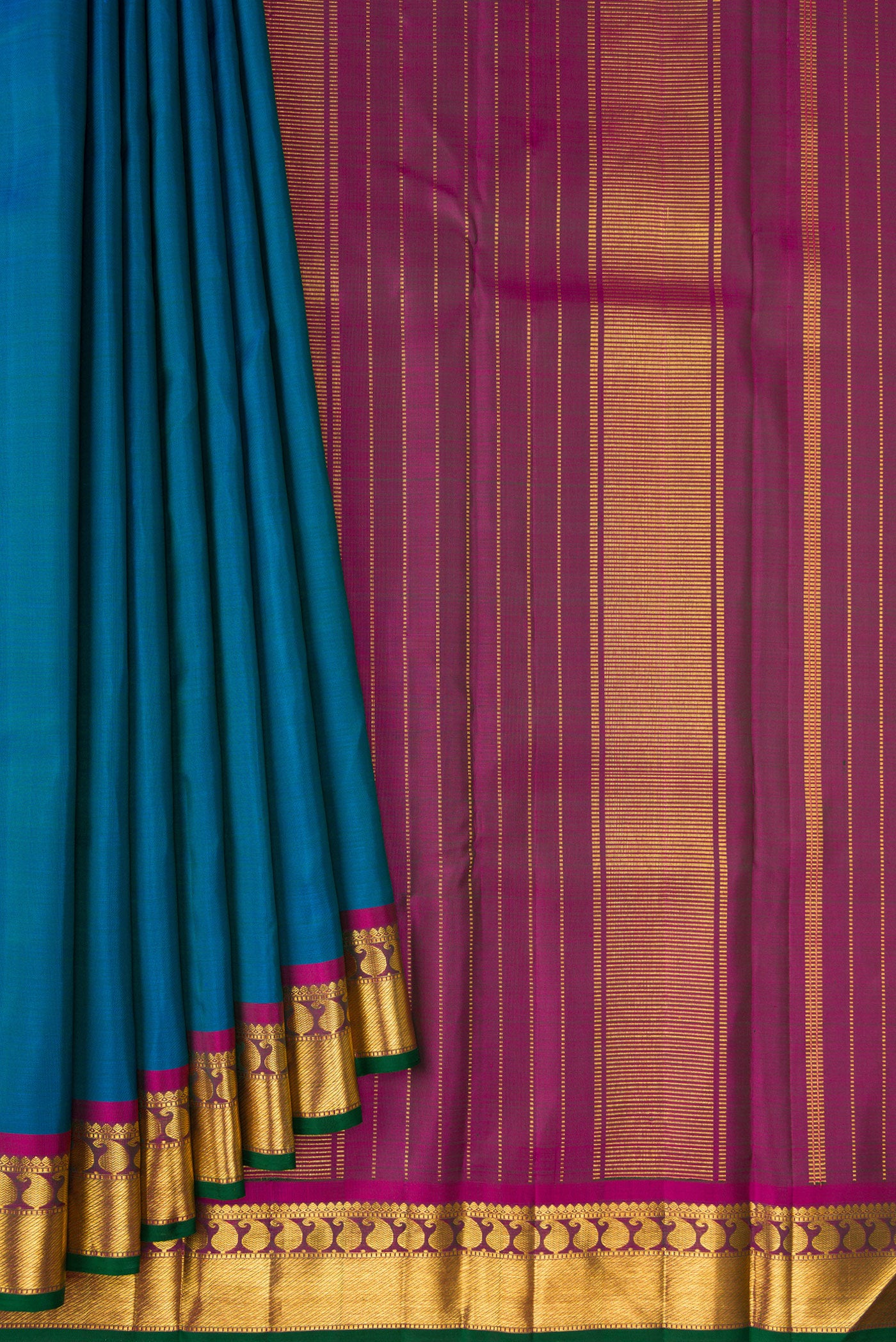 Pleats and pallu of Peacock Blue Kanchipuram Silk Saree with Plain Body and Zari Border. 