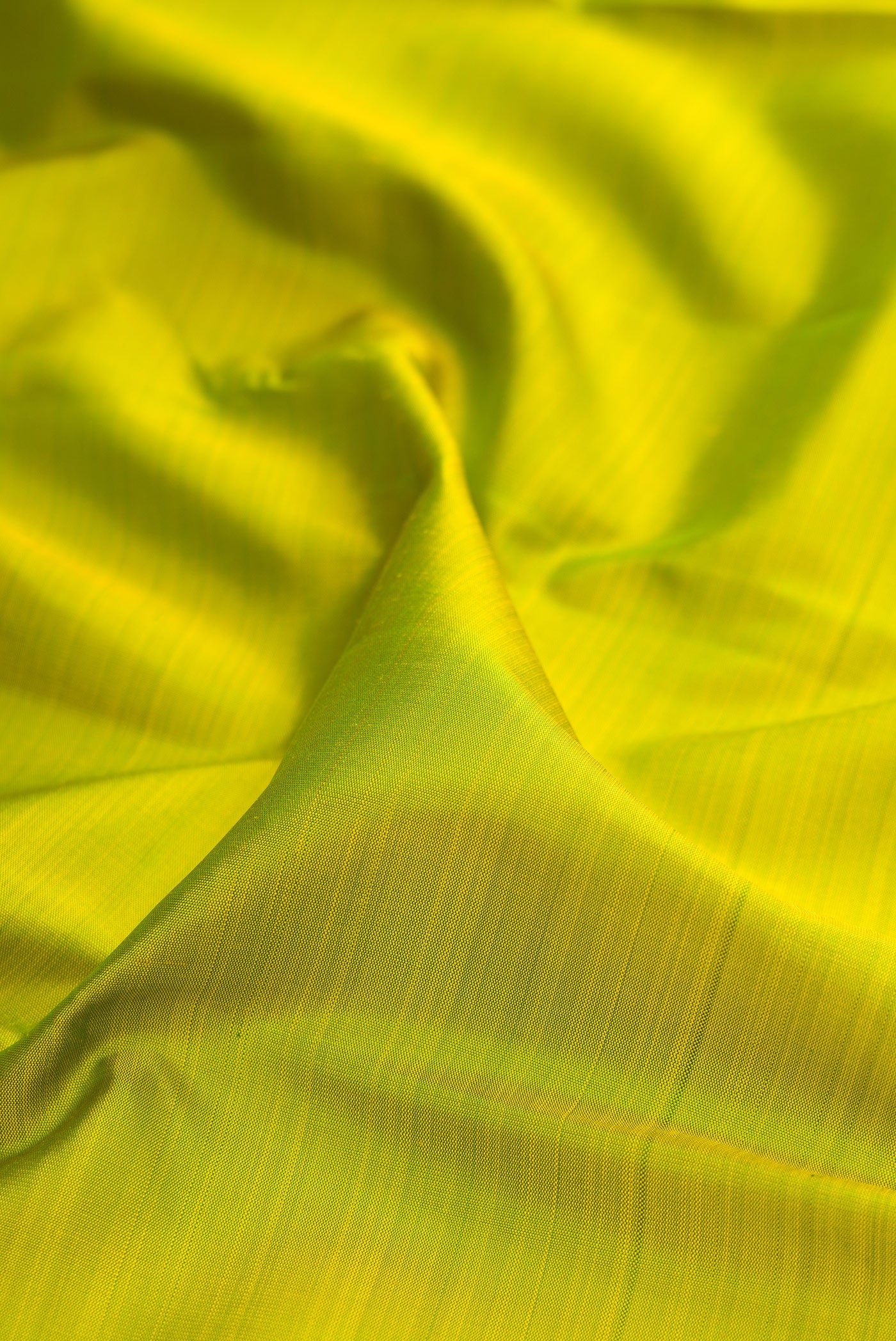 Close up of Green Kanjivaram Silk Saree with Plain Body and Temple Border.  displaying folds