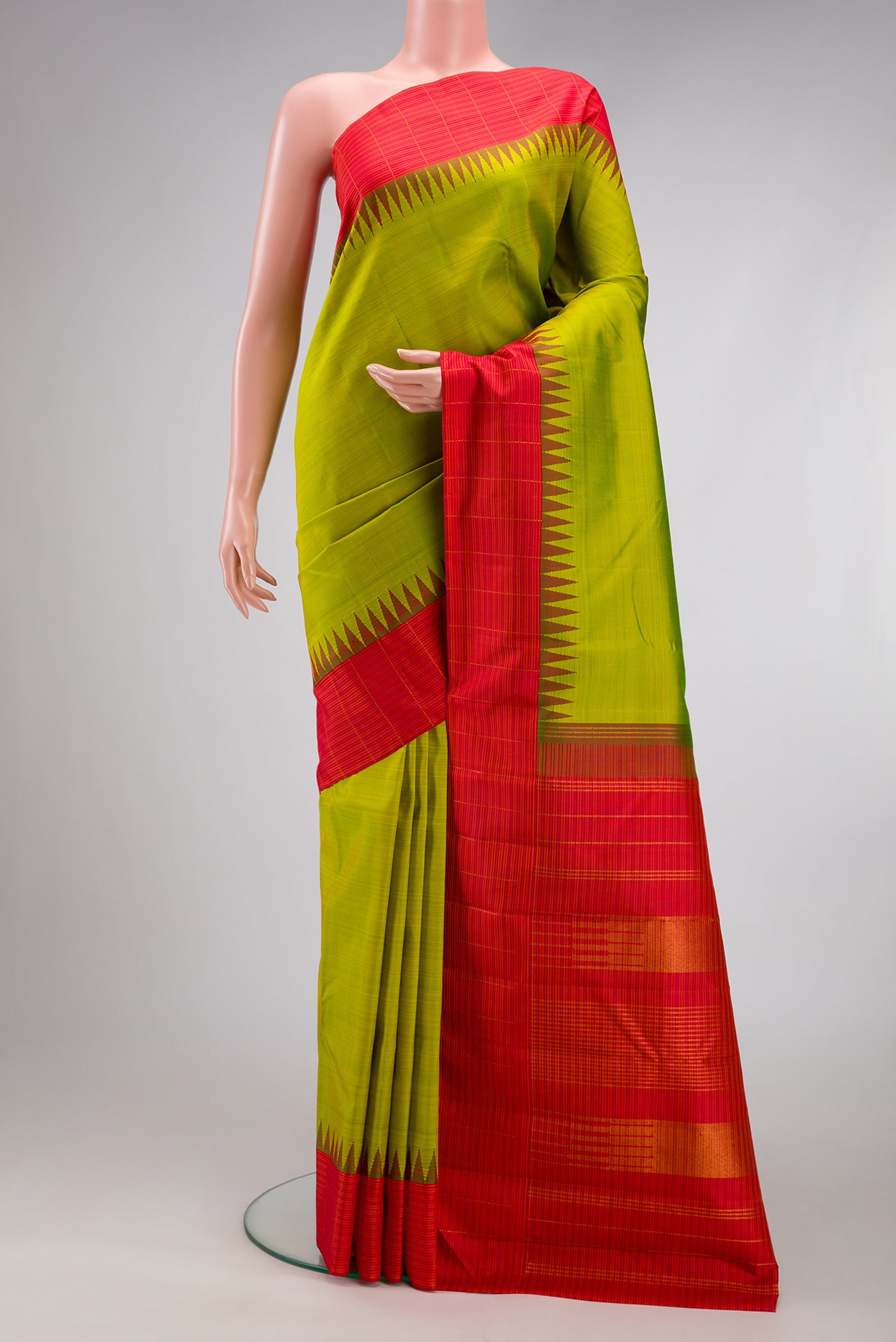 Green Kanjivaram Silk Saree with Plain Body and Temple Border.  displayed on a mannequin