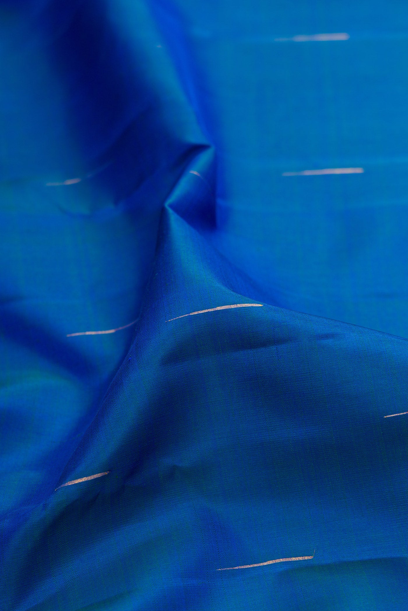Close up of Royal Blue Kanchipuram Silk Saree with Zari Butta on the body and Zari Border.  displaying folds