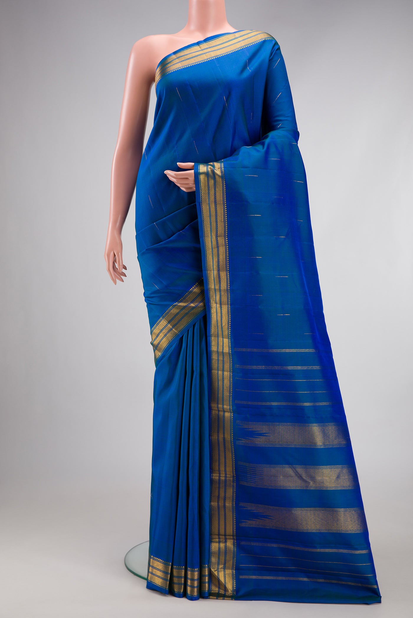 Royal Blue Kanchipuram Silk Saree with Zari Butta on the body and Zari Border.  displayed on a mannequin