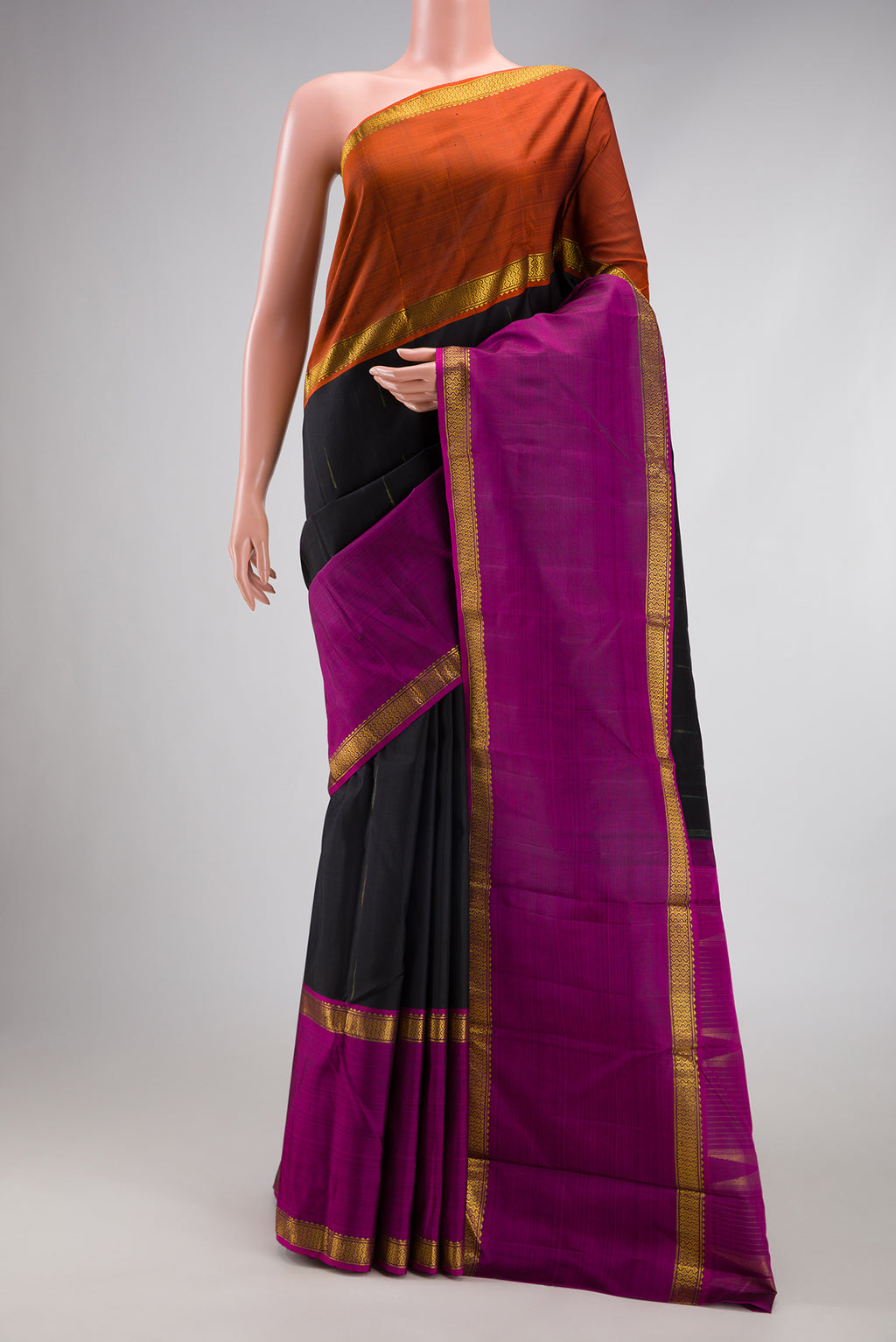 Black Kanchipuram Silk Saree with Zari Butta on the body and Ganga Jamuna Border.  displayed on a mannequin
