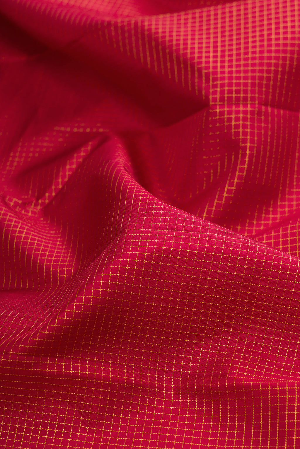 Close up of Pure Silk Maroon Kanchipuram Saree with Checked design on the body and Zari Border.  displaying folds