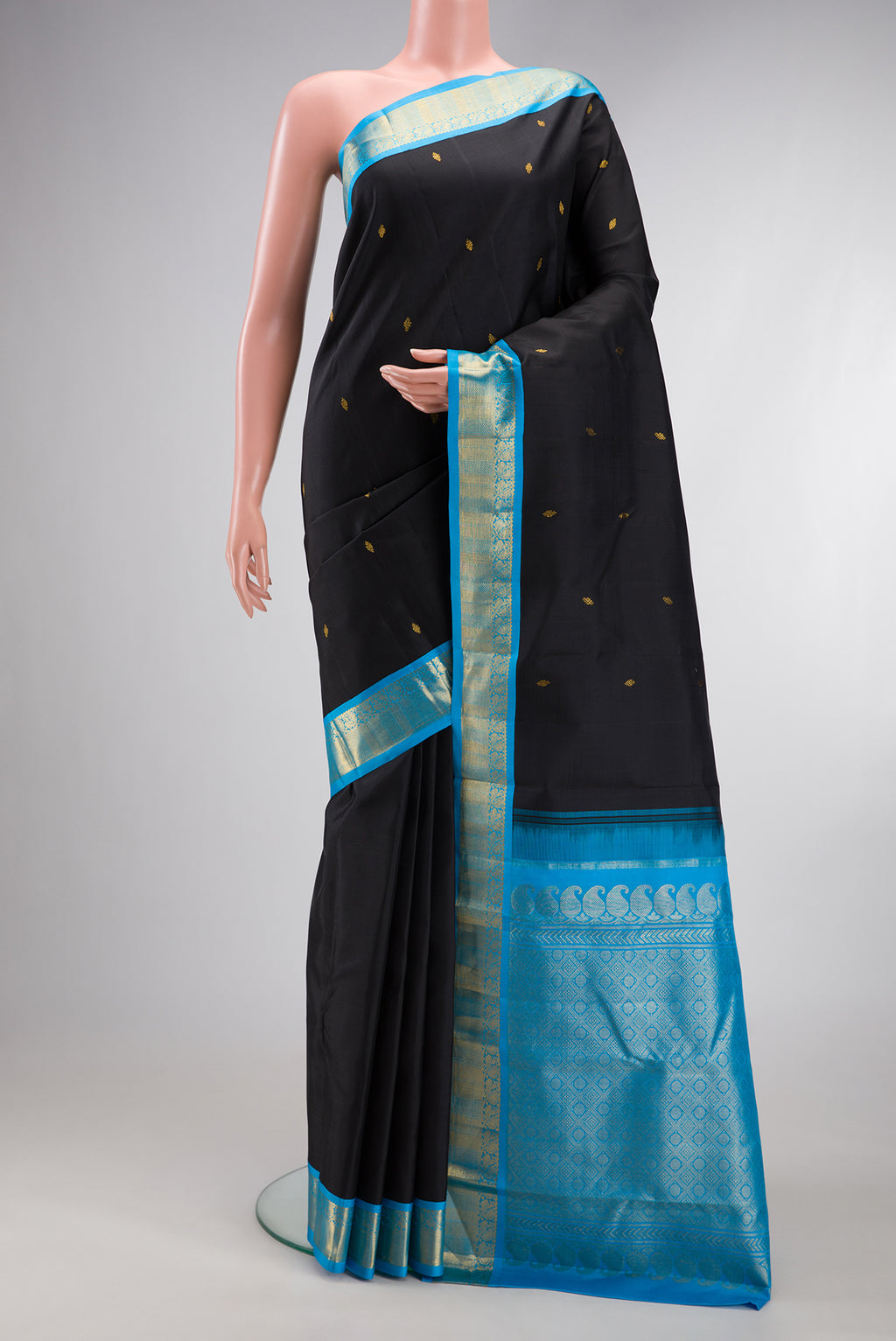 Black Kanjivaram Silk Saree with Zari Butta on the body and Zari Border.  displayed on a mannequin