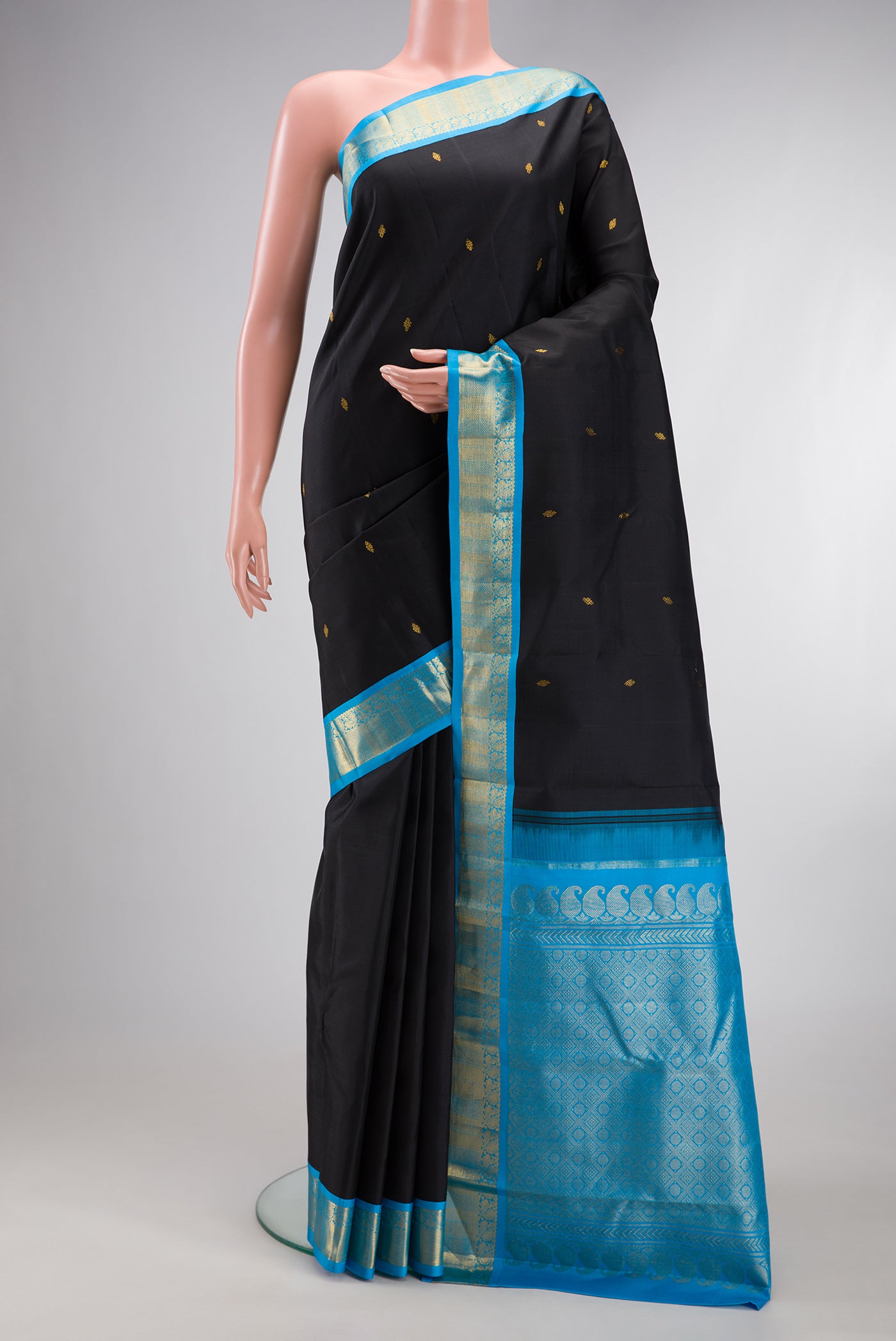 Black Kanjivaram Silk Saree with Zari Butta on the body and Zari Border.  displayed on a mannequin