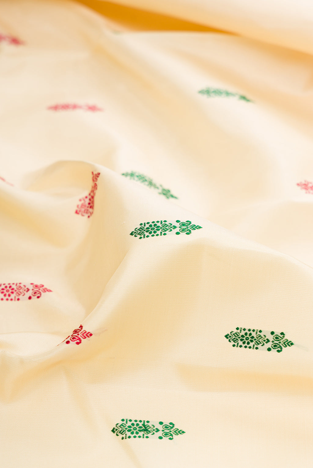 Close up of Sandal Kanjivaram Silk Saree with Thread Butta on the body and Zari Border.  displaying folds