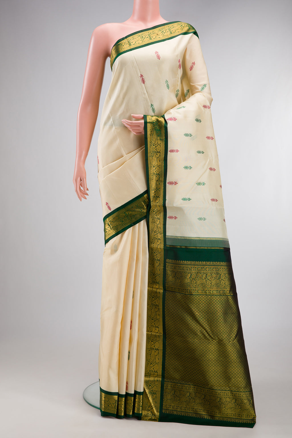 Sandal Kanjivaram Silk Saree with Thread Butta on the body and Zari Border.  displayed on a mannequin