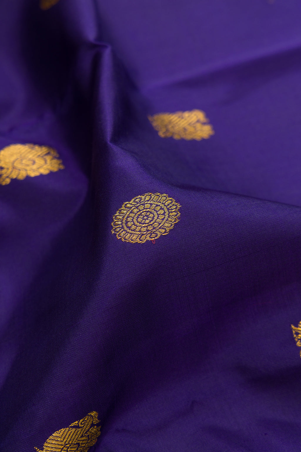 Close up of Dark Blue Kanjivaram Silk Saree with Zari Butta on the body and Zari Border.  displaying folds