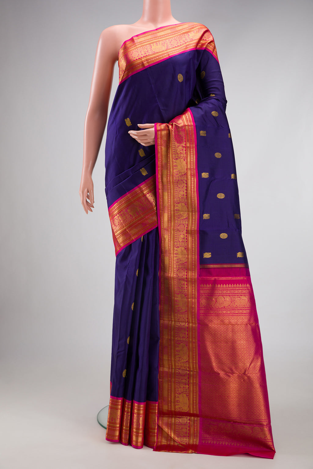 Dark Blue Kanjivaram Silk Saree with Zari Butta on the body and Zari Border.  displayed on a mannequin