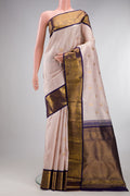 Pure Silk Rose Gold Kanjivaram Saree with Zari Butta on the body and Zari Border.  displayed on a mannequin