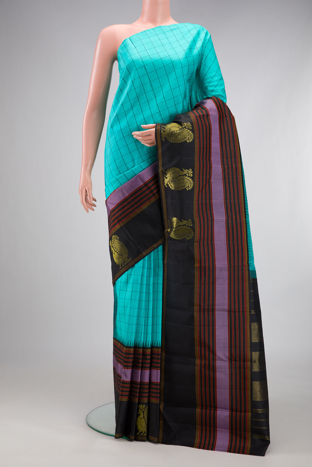 Sky Blue Kanjivaram Silk Saree with Checked design on the body and Fancy Border.  displayed on a mannequin