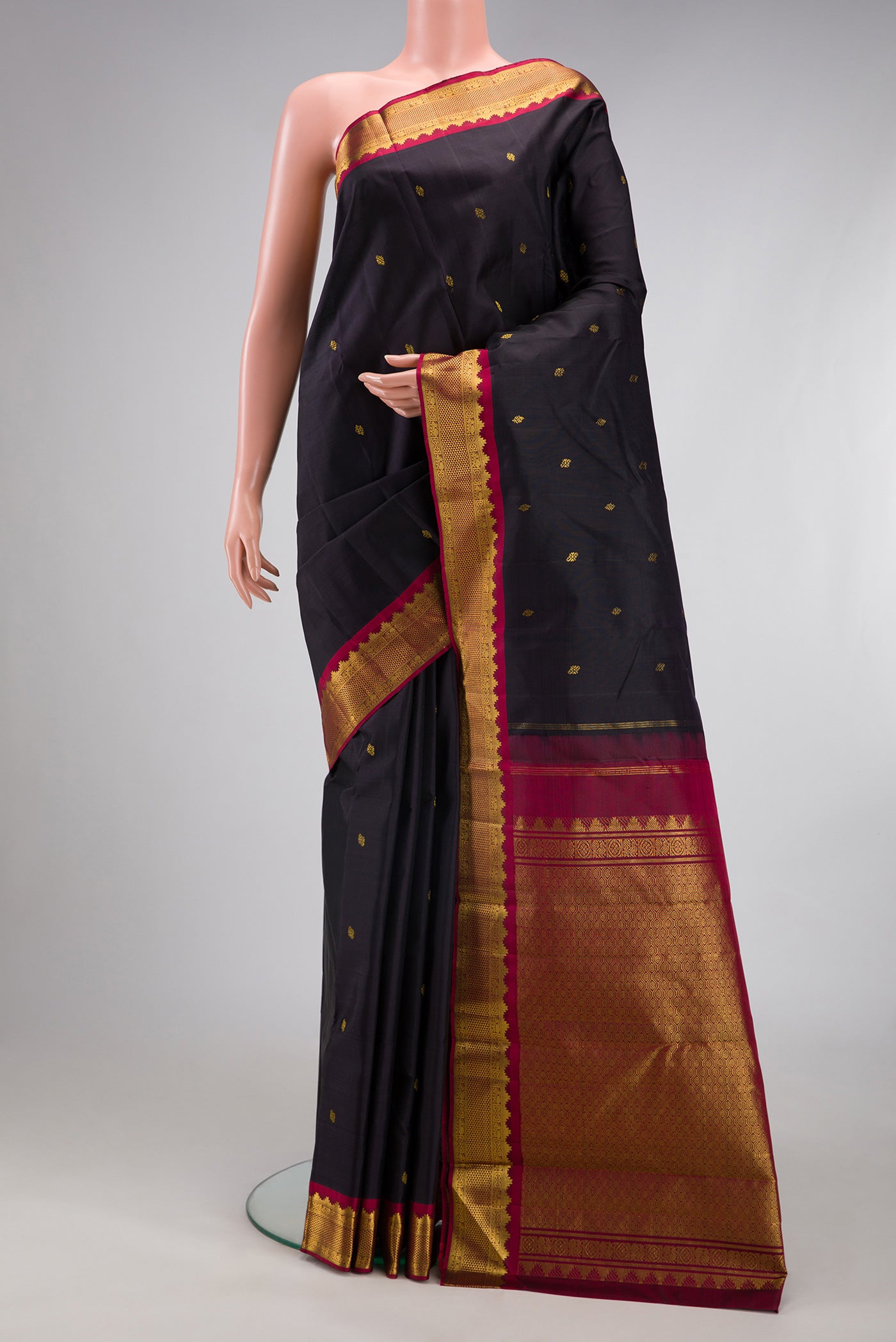 Black Kanjivaram Silk Saree with Zari Butta on the body and Zari Border.  displayed on a mannequin