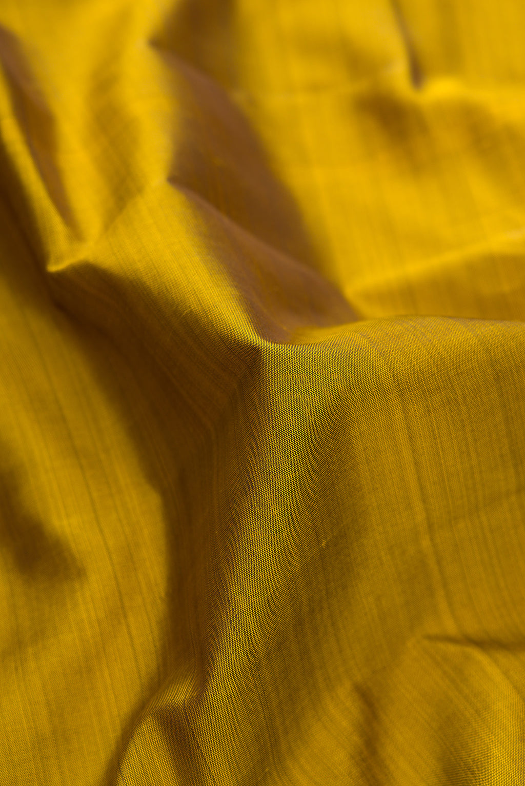 Close up of Mehandi Green Kanjivaram Silk Saree with Plain Body and Temple Border.  displaying folds