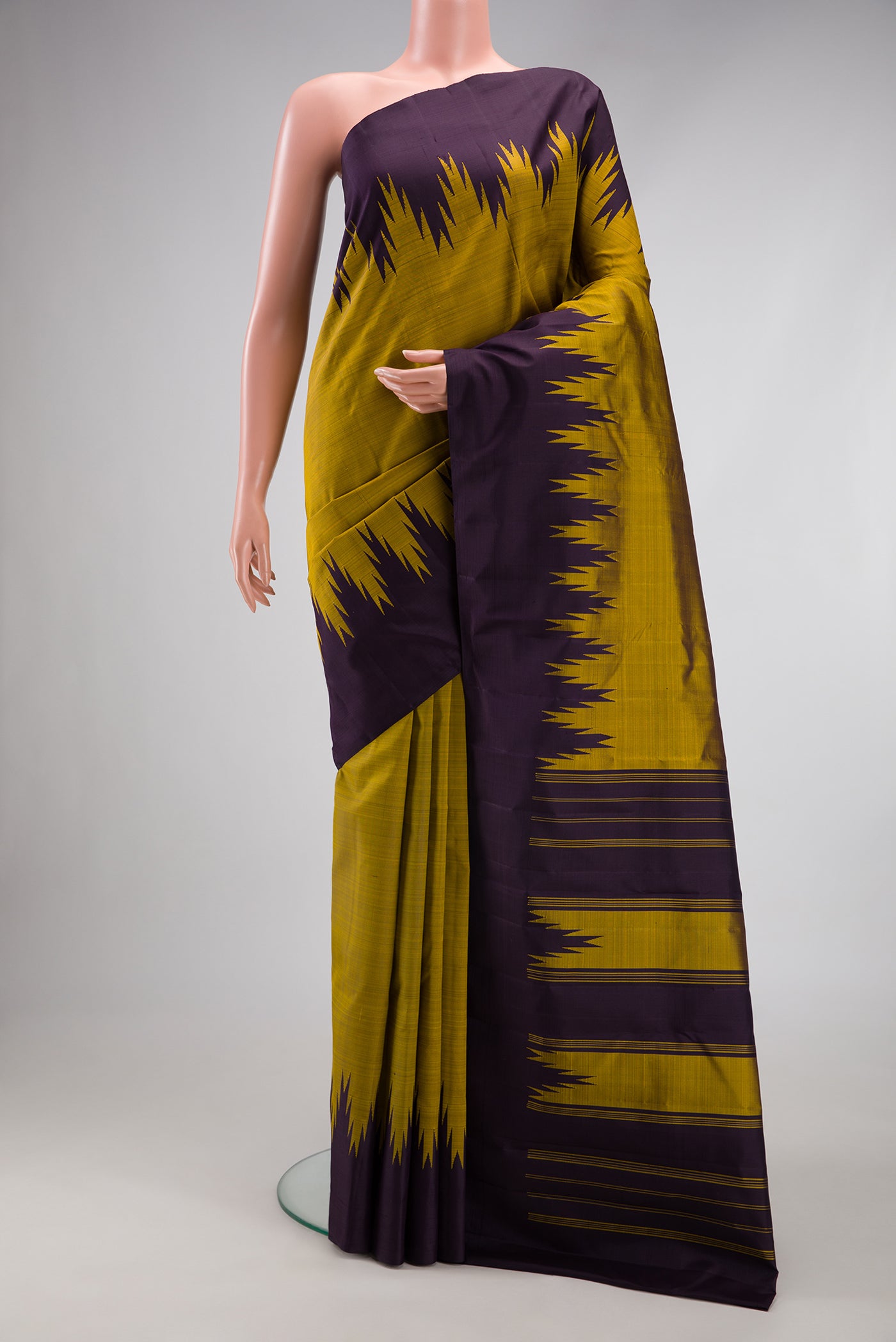 Mehandi Green Kanjivaram Silk Saree with Plain Body and Temple Border.  displayed on a mannequin