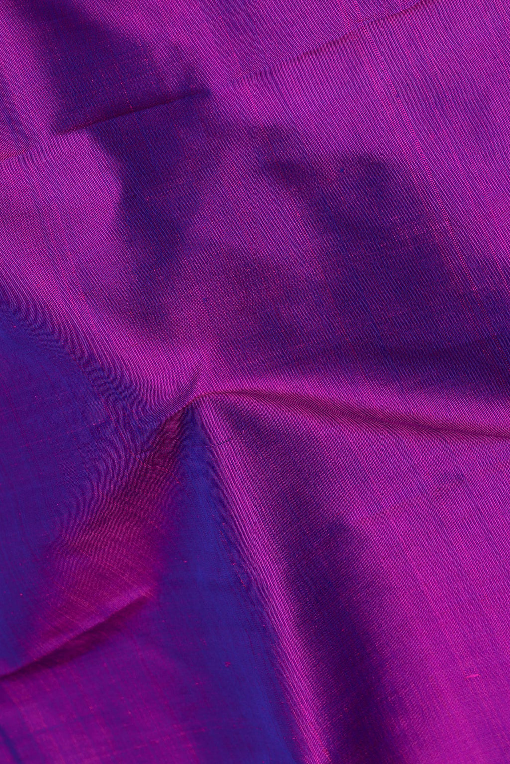 Close up of Pure Silk Pure Zari Purple Dual Tone Kanjivaram Saree with Plain Body and One Side Border.  displaying folds