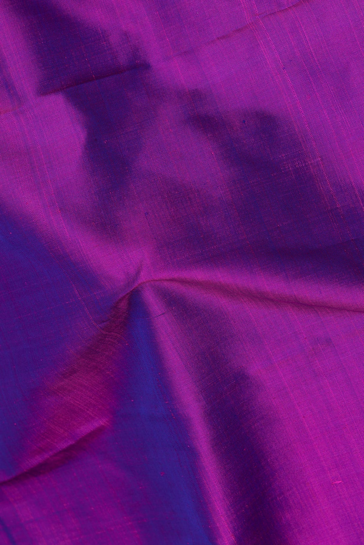 Close up of Pure Silk Pure Zari Purple Dual Tone Kanjivaram Saree with Plain Body and One Side Border.  displaying folds