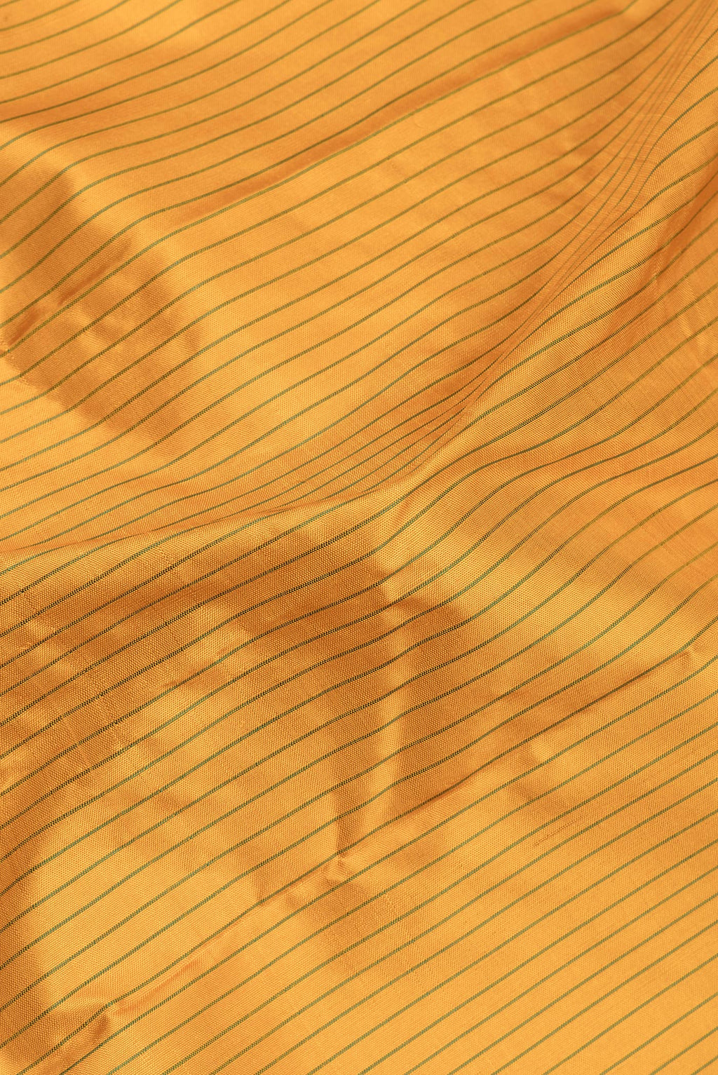 Close up of Pure Silk Pure Zari Mustard Kanjivaram Saree with Stripes on the body and One Side Border.  displaying folds