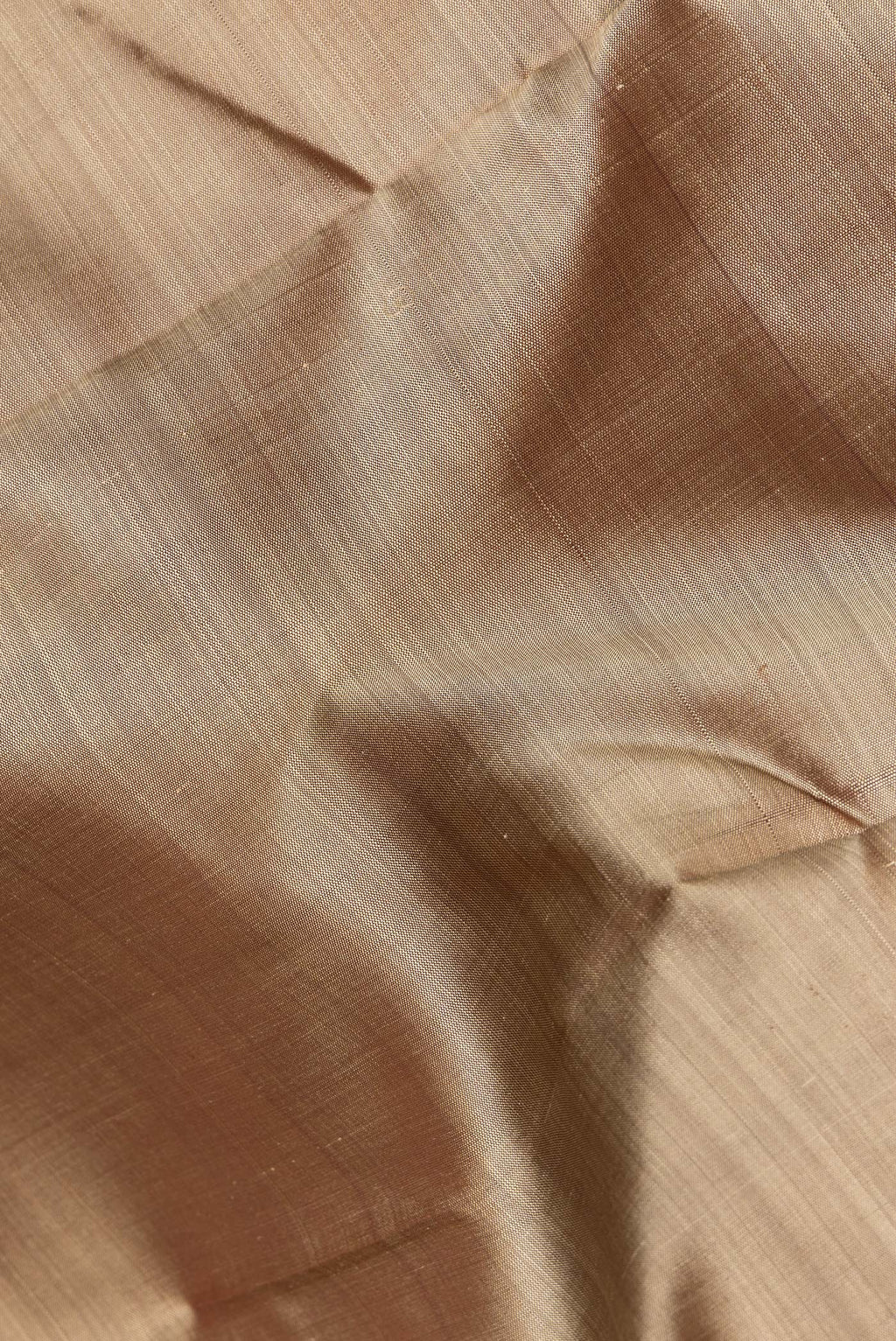 Close up of Pure Silk Pure Zari Dark Beige Dual Tone Kanjivaram Saree with Plain Body and One Side Border.  displaying folds