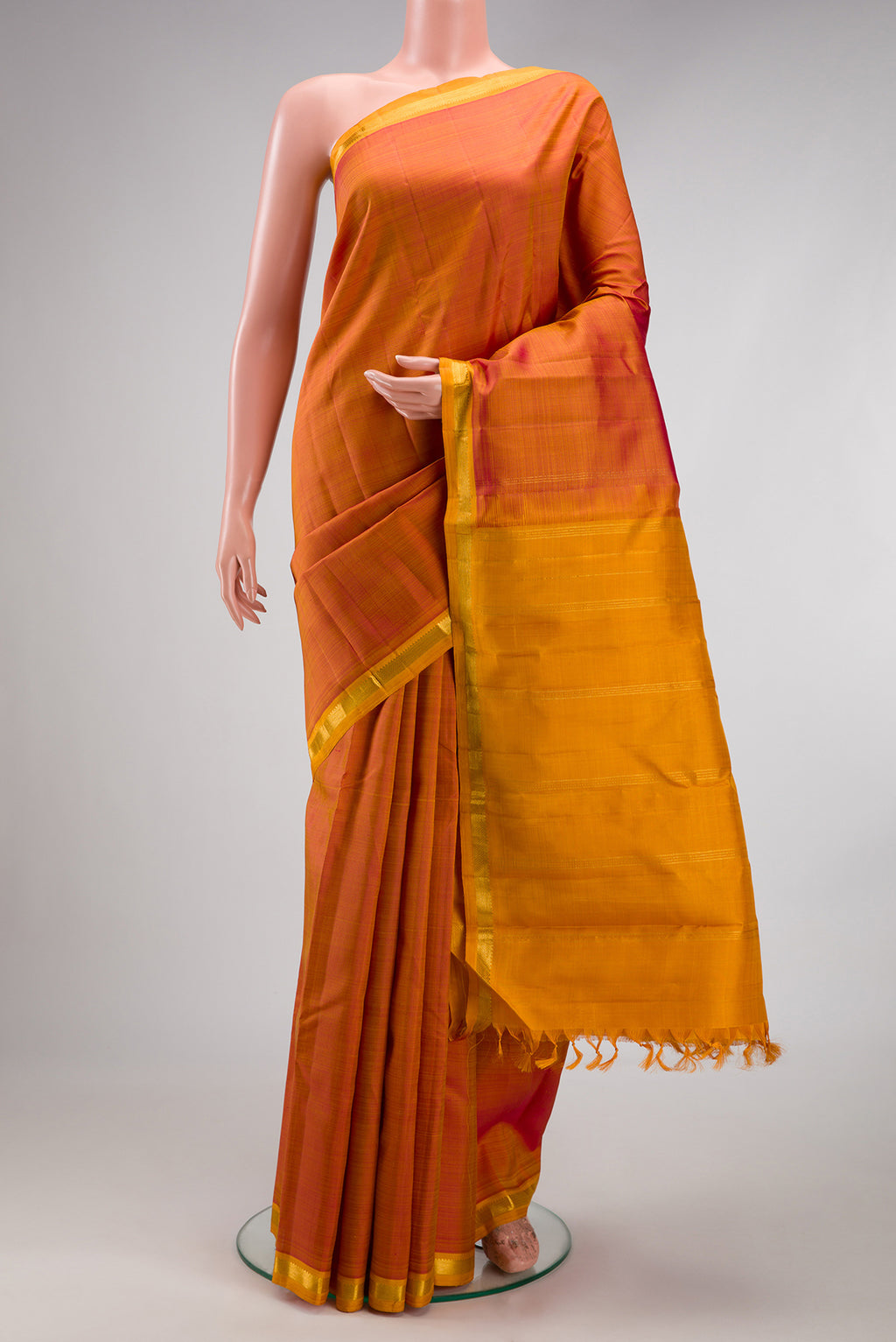 Pinkish Yellow Dual Tone Kanjivaram Silk Saree with Plain Body and Zari Border.  displayed on a mannequin
