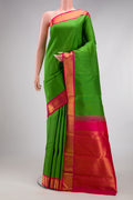 Green Kanjivaram Silk Saree with Plain Body and Zari Border.  displayed on a mannequin