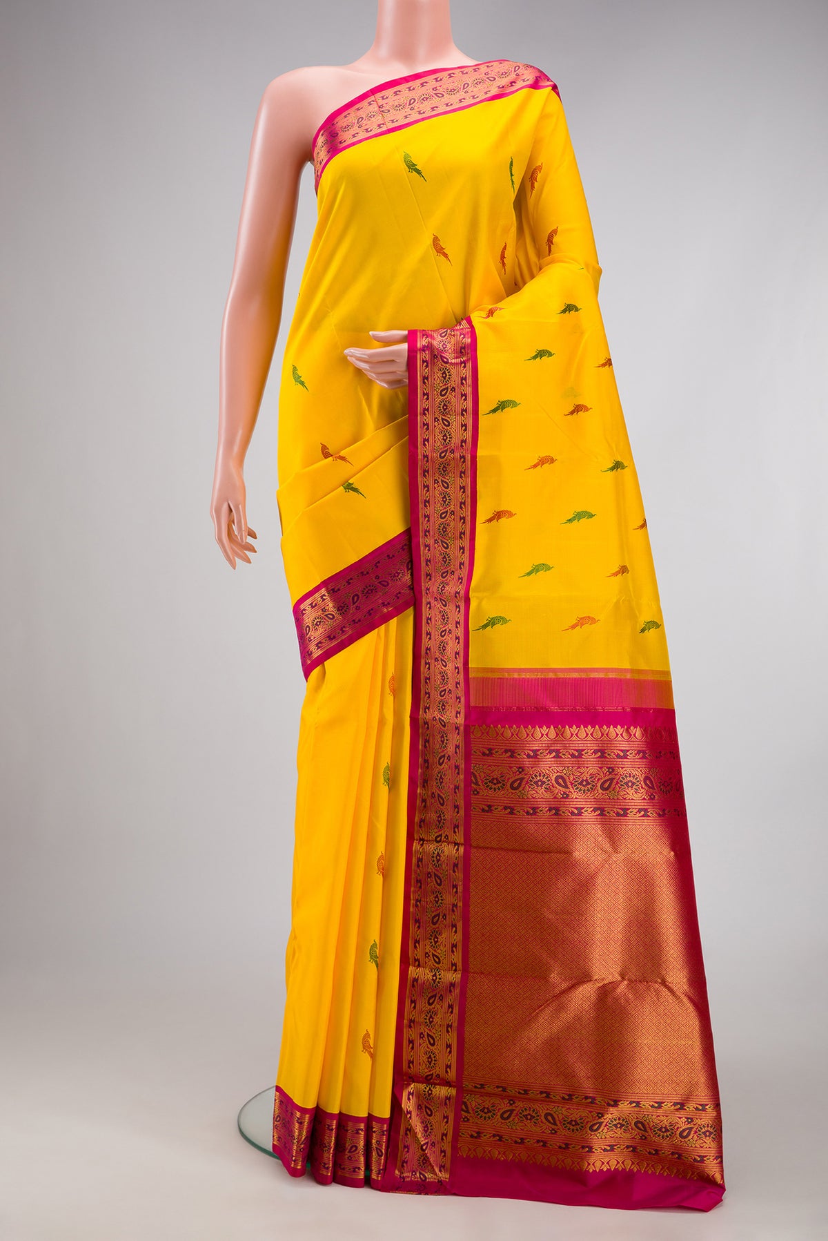 Yellow Kanjivaram Silk Saree with Thread Butta on the body and Fancy Border.  displayed on a mannequin