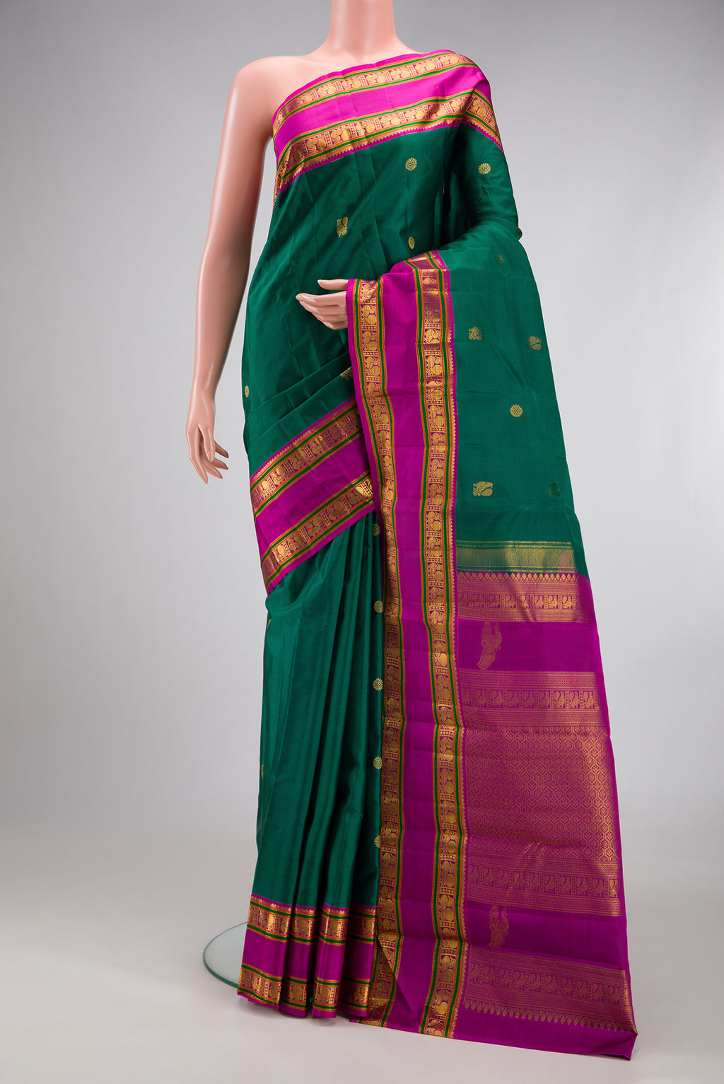 Teal Kanchipuram Silk Saree with Zari Butta on the body and Zari Border.  displayed on a mannequin