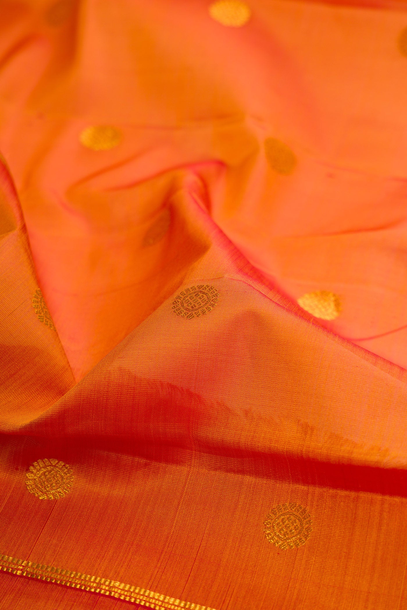 Close up of Mustard Kanchipuram Silk Saree with Zari Butta on the body and Zari Border.  displaying folds