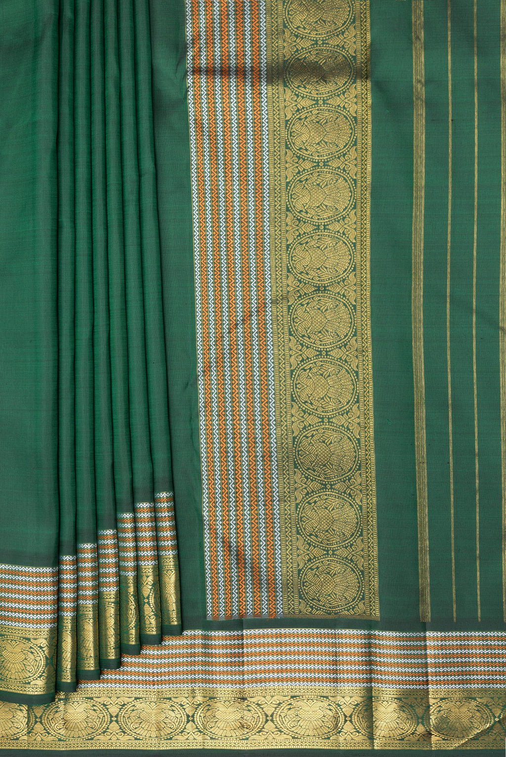 Pleats and pallu of Pure Silk Bottle Green Kanchipuram Saree with Plain Body and Zari Border. 