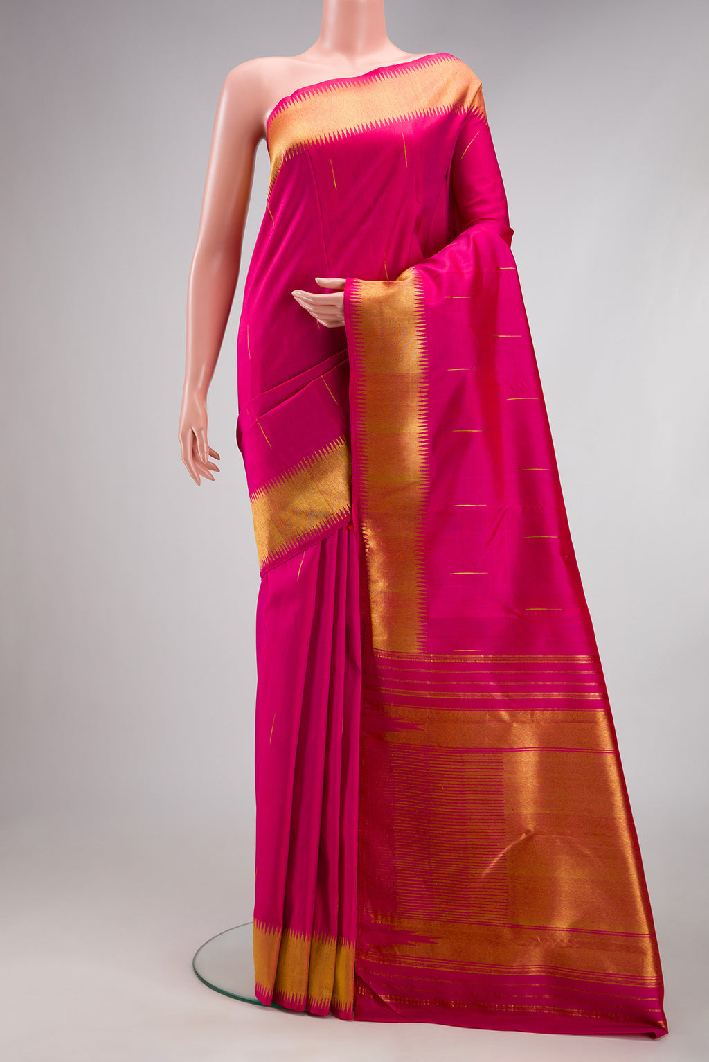 Dark Pink Kanjivaram Silk Saree with Zari Butta on the body and Zari Border.  displayed on a mannequin