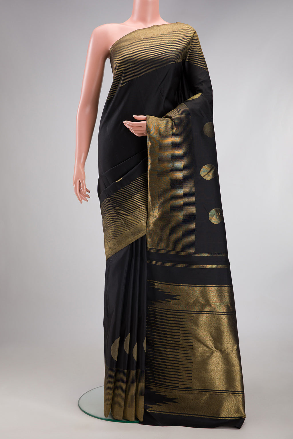 Black Kanchipuram Silk Saree with Plain Body and Zari Border.  displayed on a mannequin
