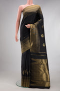 Black Kanchipuram Silk Saree with Plain Body and Zari Border.  displayed on a mannequin