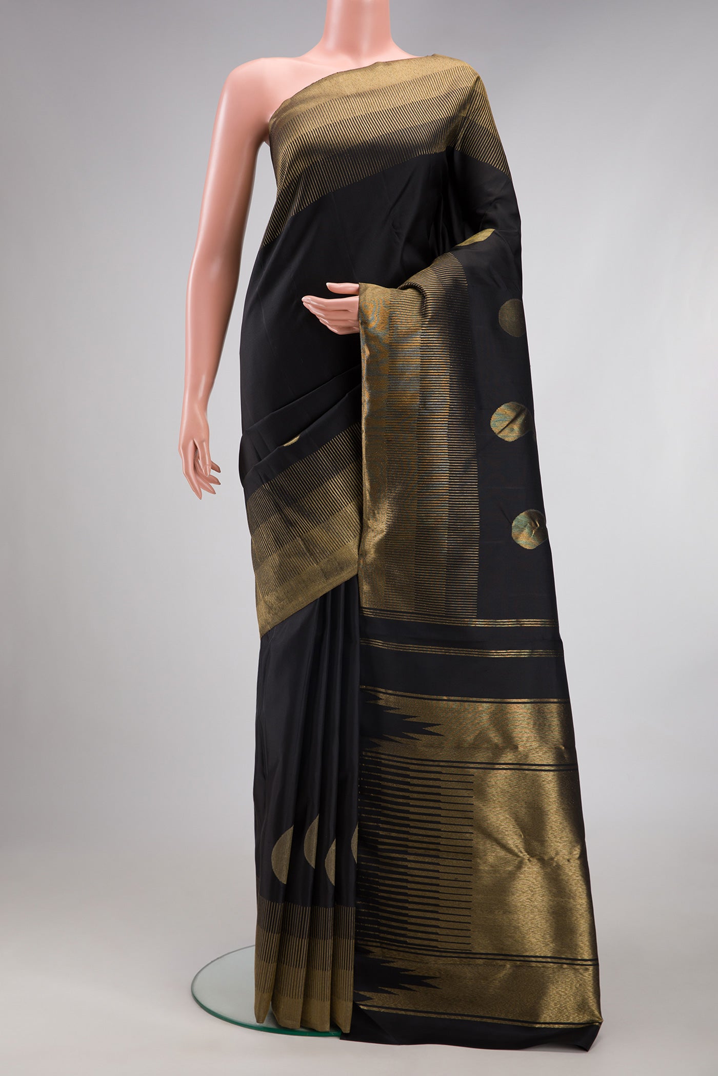 Black Kanchipuram Silk Saree with Plain Body and Zari Border.  displayed on a mannequin