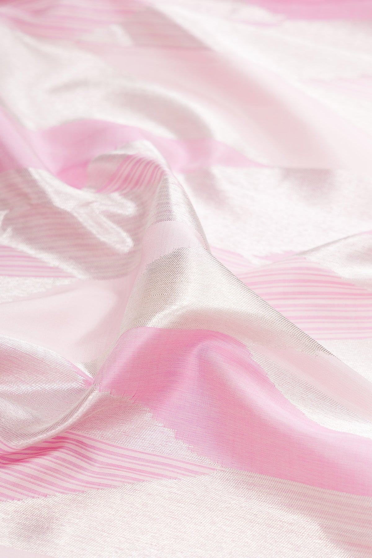 Close up of Pure Silk Rose pink Kanchipuram Saree with Zari Brocade on the body and Zari Border.  displaying folds
