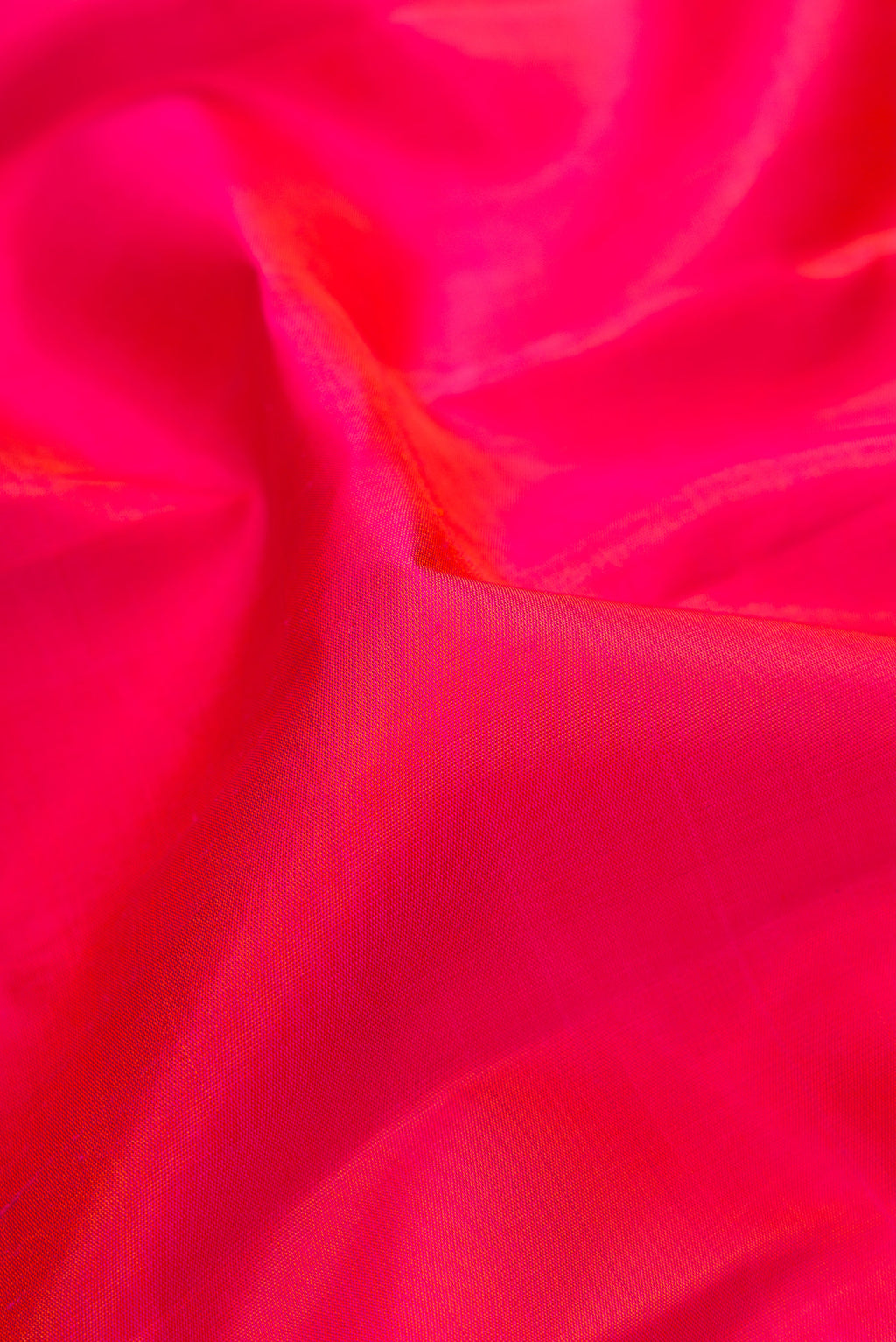 Close up of Pink Dual Tone Kanchipuram Silk Saree with Plain Body and Zari Border.  displaying folds