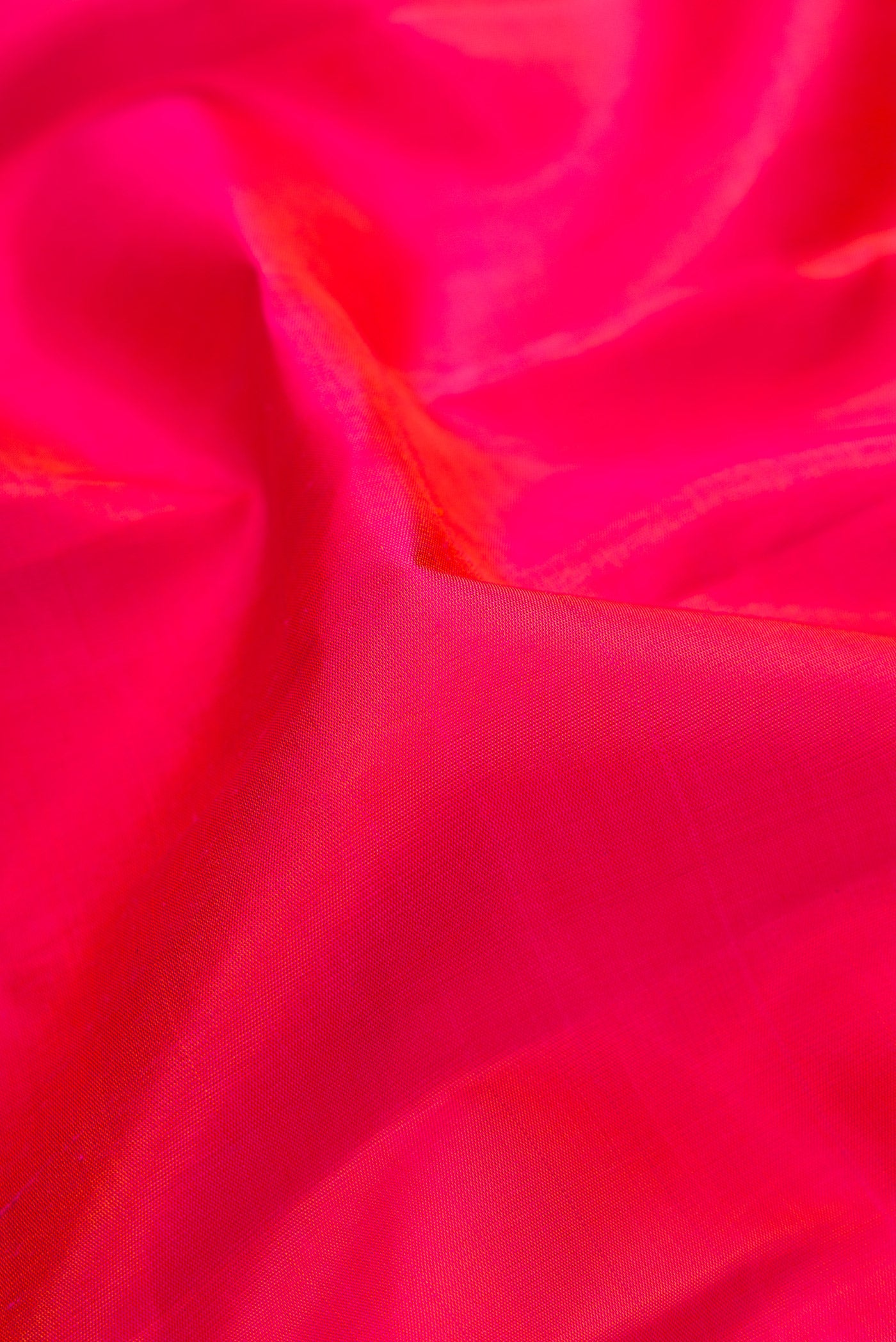 Close up of Pink Dual Tone Kanchipuram Silk Saree with Plain Body and Zari Border.  displaying folds