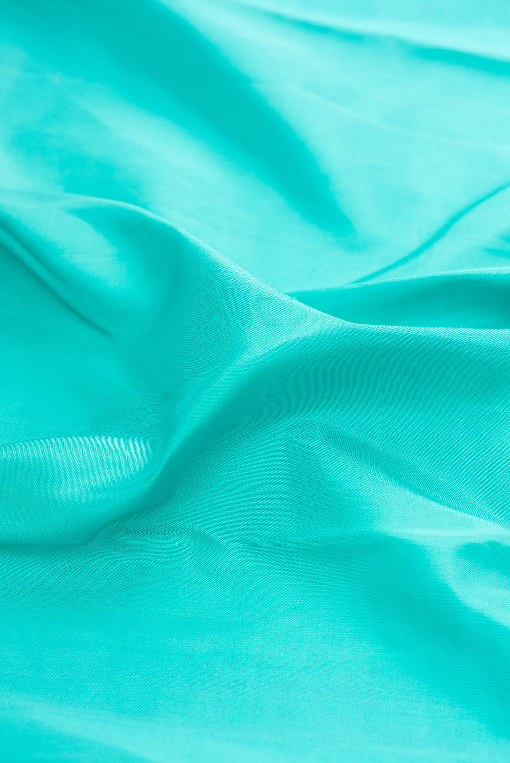Close up of Pure Silk Pure Zari Turquoise Kanchipuram Saree with Plain Body and Temple Border.  displaying folds