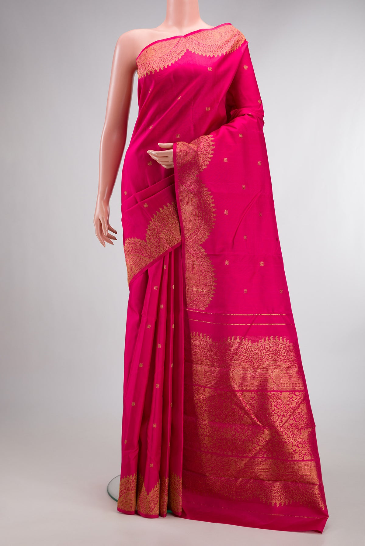 Pure Silk Pure Zari Pink Kanjivaram Saree with Zari Butta on the body and Fancy Border.  displayed on a mannequin